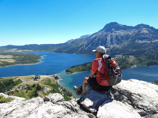 A man wearing LOWA Camino GTX boots looking at the view over the Waterton Lakes National Park