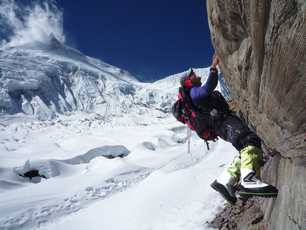 Emmanuel Daigle of the Haute Montagne Academy climbing a rock formation with his LOWA Alpine boots