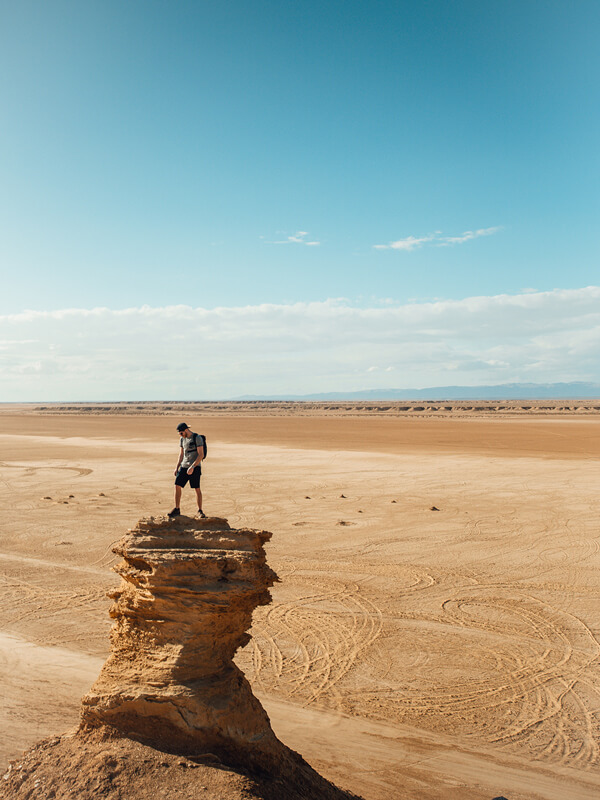 Benoit Chamberland on the top of a rock formation in the desert